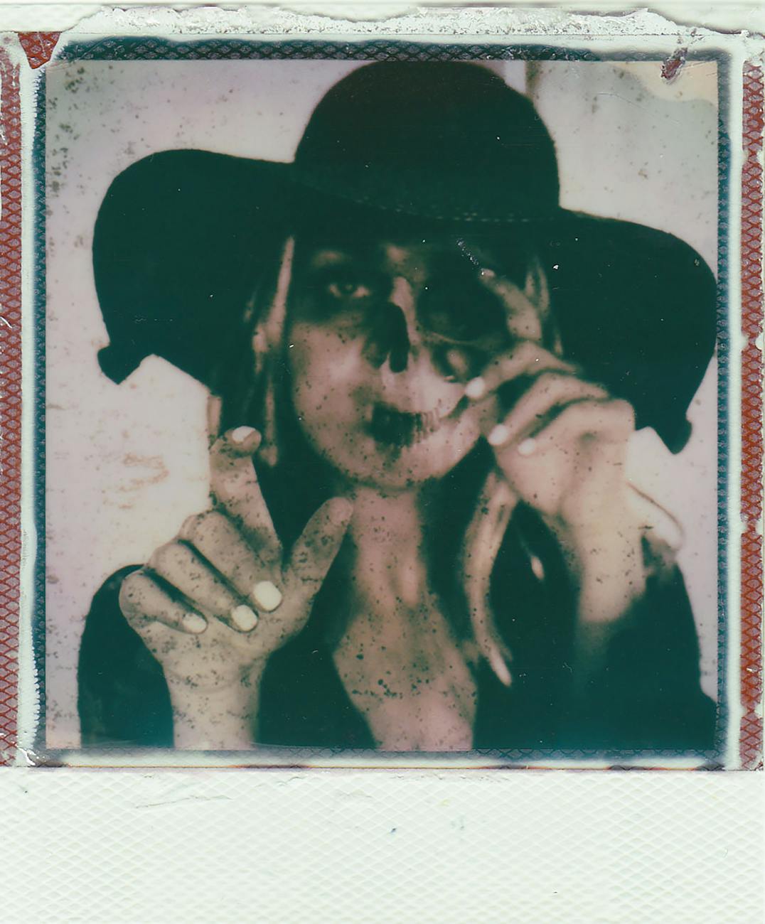 polaroid picture of woman in halloween costume and skull makeup